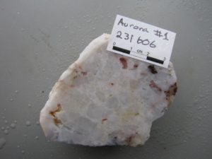 PLATE 1: Coarse euhedral buck quartz vein texture consisting of tightly packed crystals of variable size and orientation with little open space. Sample from the Aurora Mine, International Camp (Georgetown). Sample #231606; 0.15 g/t Au, 1.3 g/t Ag.