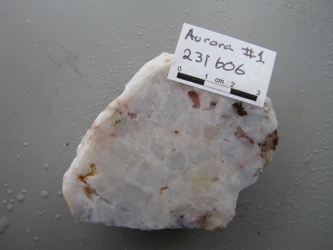 PLATE 1: Coarse euhedral buck quartz vein texture consisting of tightly packed crystals of variable size and orientation with little open space. Sample from the Aurora Mine, International Camp (Georgetown). Sample #231606; 0.15 g/t Au, 1.3 g/t Ag.